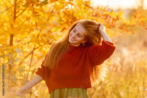 Happy teenage girl walking in autumn nature