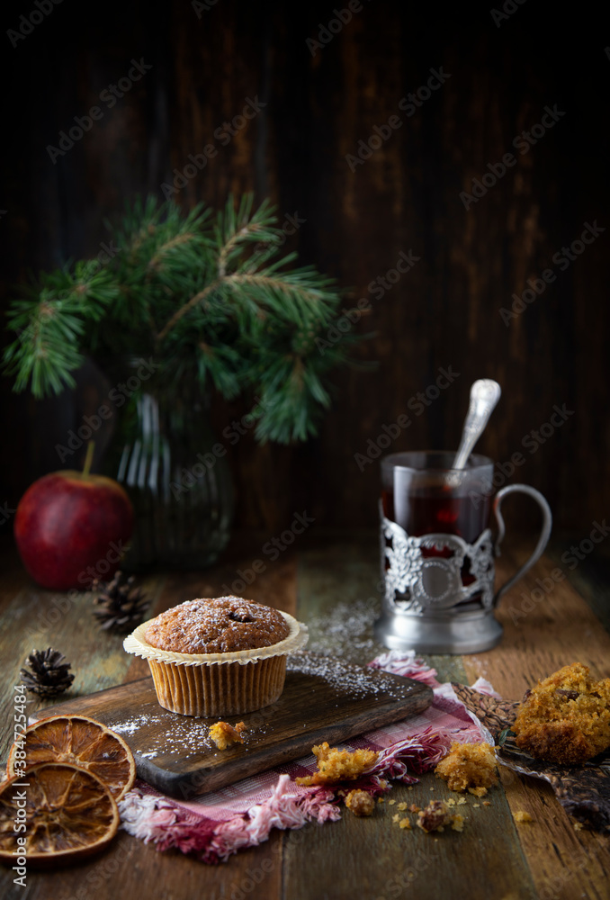 
Cupcakes and glass with tea on a wooden table
