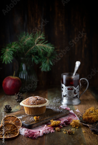  Cupcakes and glass with tea on a wooden table