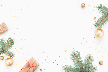 Christmas frame of green branches, gifts, gold decorations on white background. Holiday Copy space, flat lay.