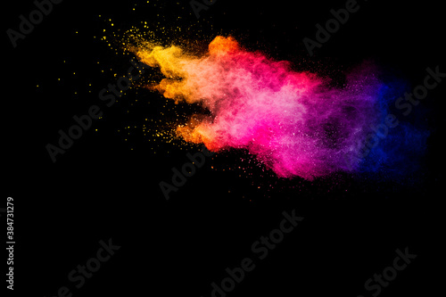 Explosion of multicolored powder isolated on black background.