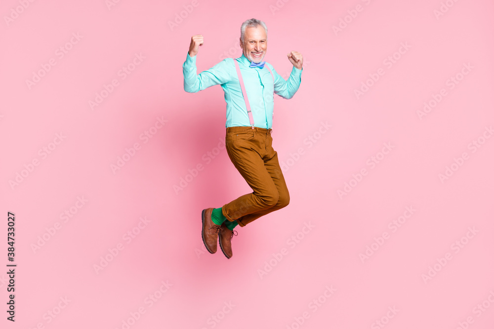 Fototapeta premium Full length body size side profile photo of smiling elder man jumping high wearing retro clothes isolated on pink color background