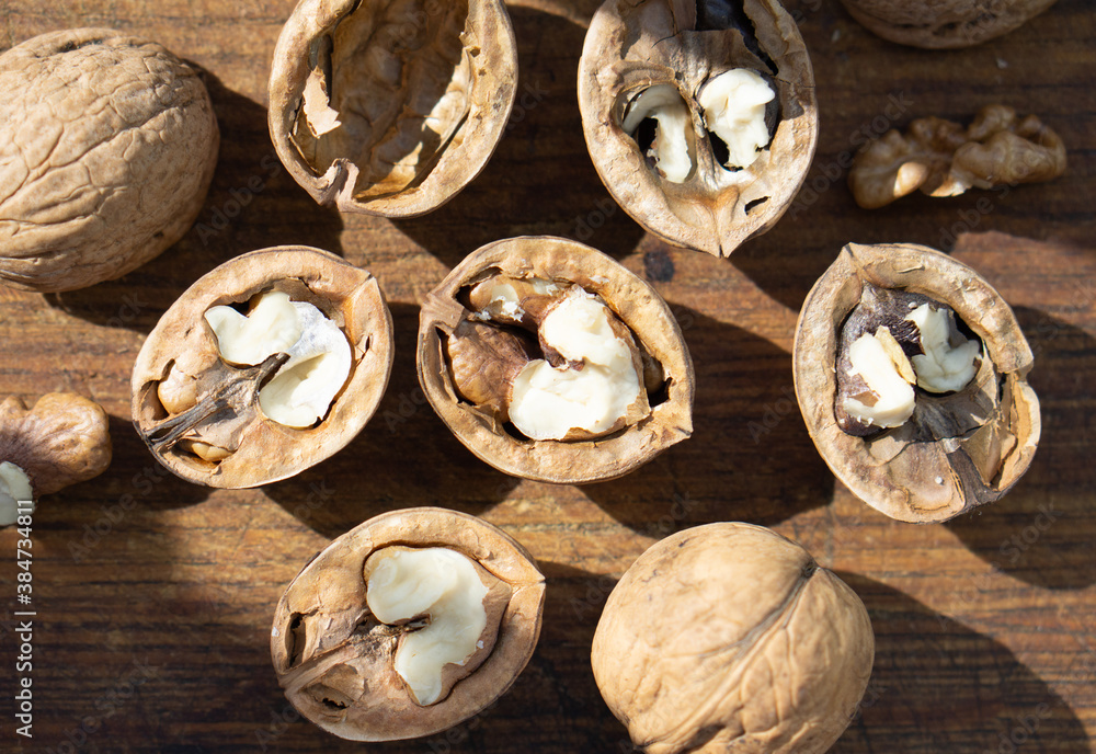 Walnuts in shells lie on a wooden surface Walnuts in shells lie on a wooden surface