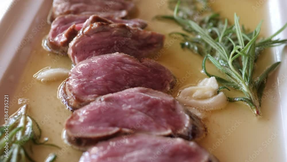 Chef in the open kitchen cooking beef slices on the plate with spices Chef in the open kitchen cooking beef slices on the plate with spices