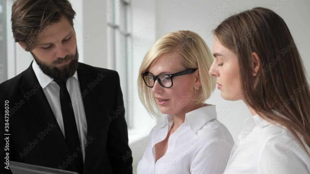 Real Estate Agent Shows Stylish Modern Apartment to a Beautiful Young Couple who are Interested in Purchasing/ Buying/ Renting. Real Estate Agent Shows Stylish Modern Apartment to a Beautiful Young Couple who are Interested in Purchasing/ Buying/ Renting.