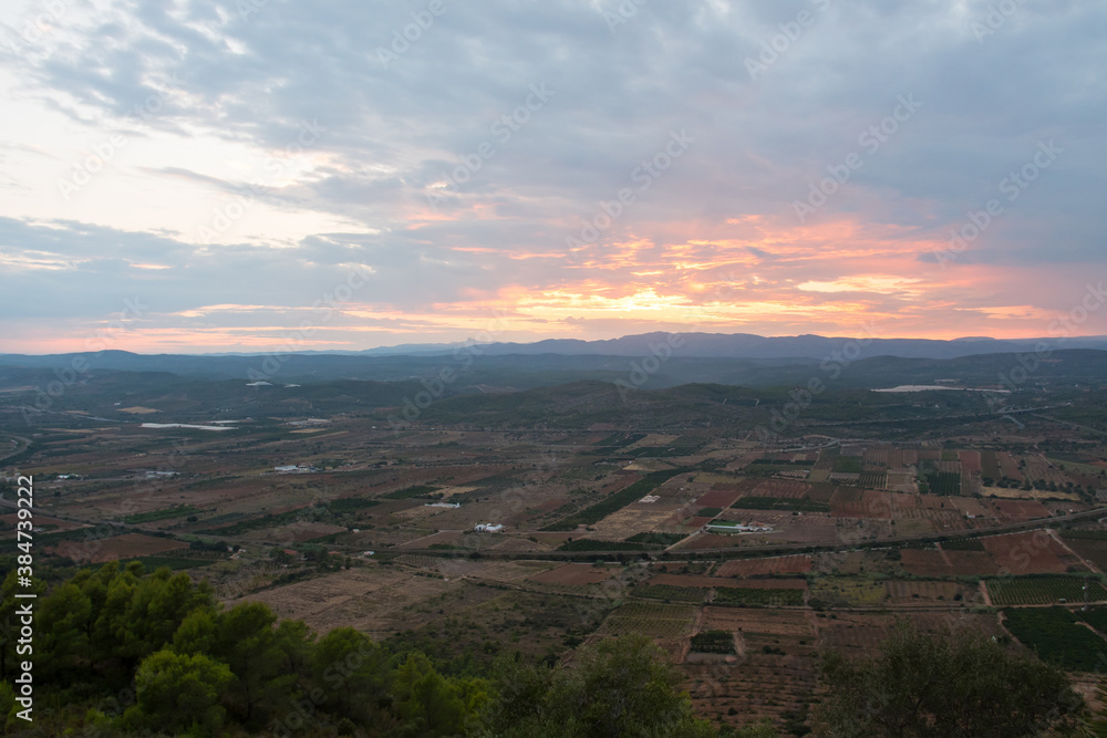 Spanish plains & hills from the Santa Lucia belvedere (Alcossebre or Alcala de Xivert, Spain). Beautiful view of magnificent nature during sunset. Cloudy day on the panoramic spot.