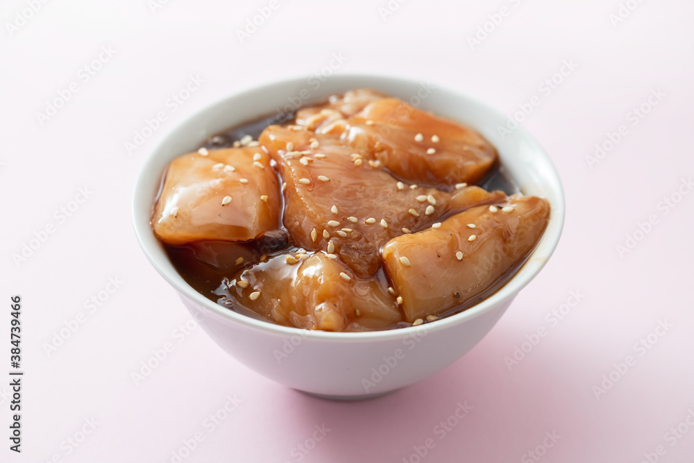 raw chicken with sauce and sesame in white bowl raw chicken with sauce and sesame in white bowl