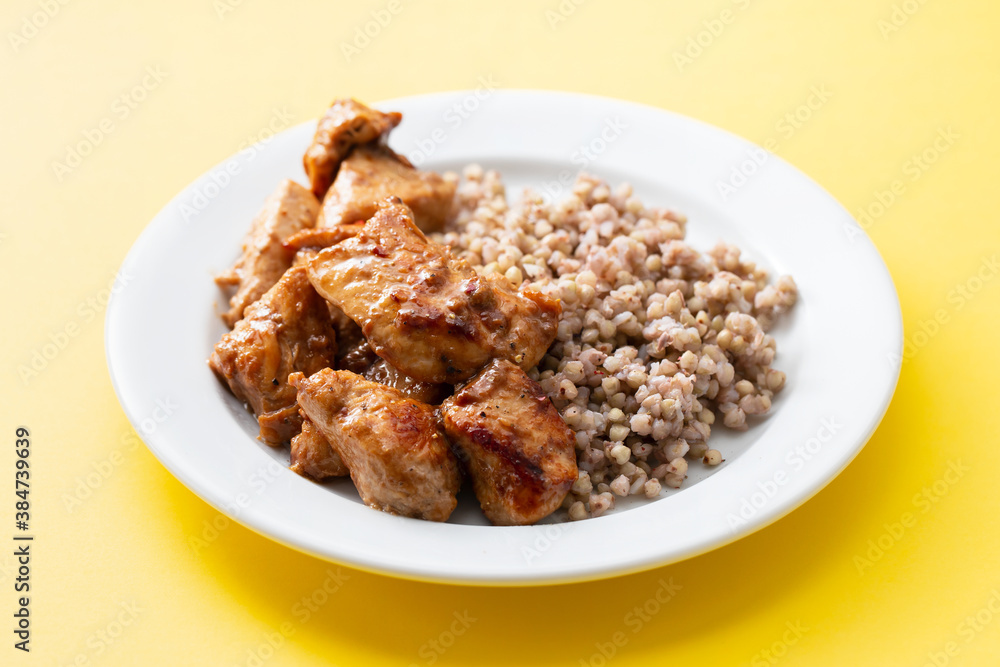 boiled buchwheat with chicken in sauce on white plate boiled buchwheat with chicken in sauce on white plate