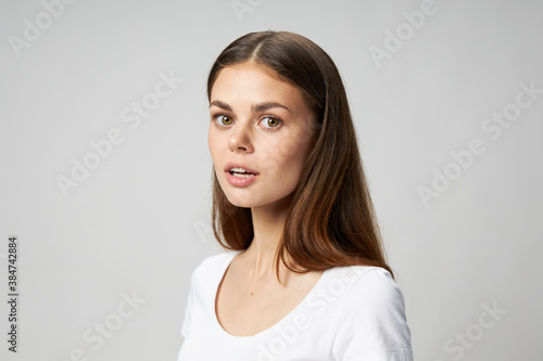 Side view of surprised woman with open mouth in t-shirt
