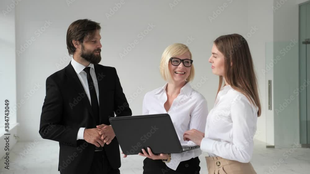 Real Estate Agent Shows Stylish Modern Office to a Beautiful Young Couple who are Interested in Purchasing/ Buying/ Renting. Real Estate Agent Shows Stylish Modern Office to a Beautiful Young Couple who are Interested in Purchasing/ Buying/ Renting.