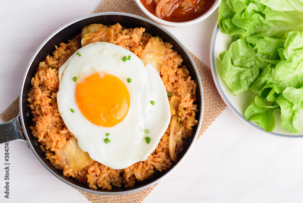 Korean food, Kimchi fried rice with fried egg in cooking pan, Top view Korean food, Kimchi fried rice with fried egg in cooking pan, Top view