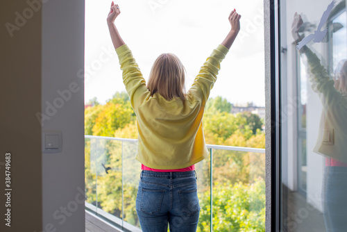 Young happy woman is working from home with laptop and sitting on sofa. Beautiful young woman working on laptop at home. Home office. Coronavirus concept. Quarantine. Cozy home