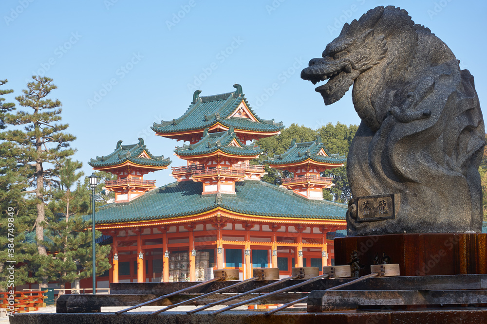 Naklejka premium Dragon statue over water ablution basin with Byakko-ro Tower of Heian-jingu Shrine. Kyoto. Japan
