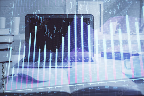 Stock market graph on background with desk and personal computer. Multi exposure. Concept of financial analysis. © peshkova