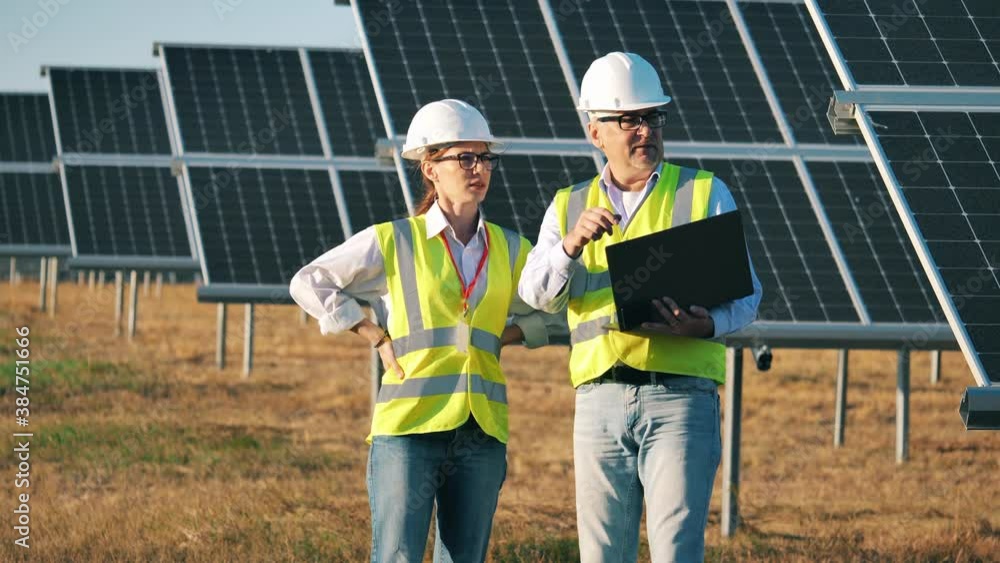 Two energetics specialists are talking about solar batteries Two energetics specialists are talking about solar batteries
