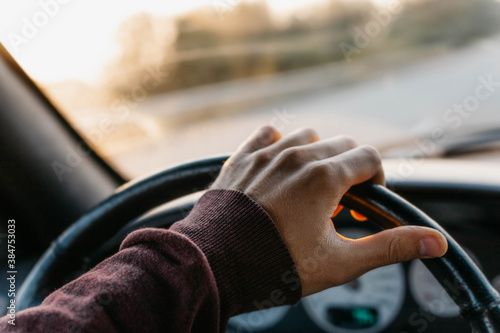 Wallpaper Mural concept of working as a driver, hand on the steering wheel at sunset. Torontodigital.ca