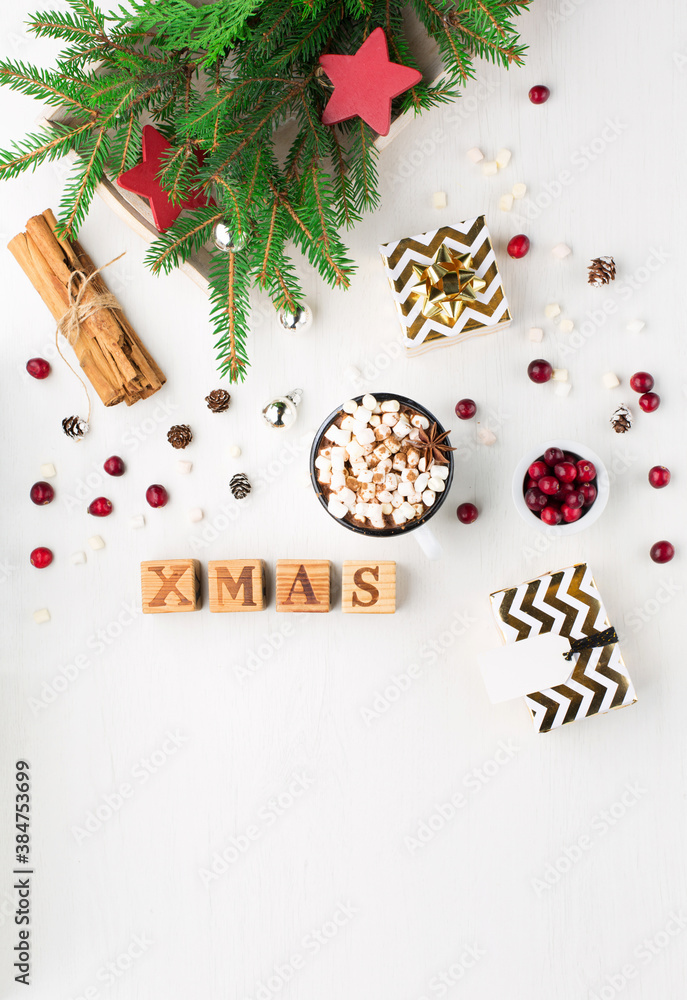 Christmas decoration, cup of coffee, homemade sweet gingerbread cookies, pine cones and branches on white wooden background. Christmas decoration, cup of coffee, homemade sweet gingerbread cookies, pine cones and branches on white wooden background.