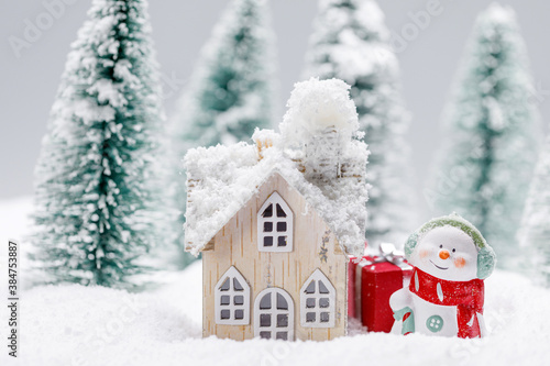 Snowman and house in winter