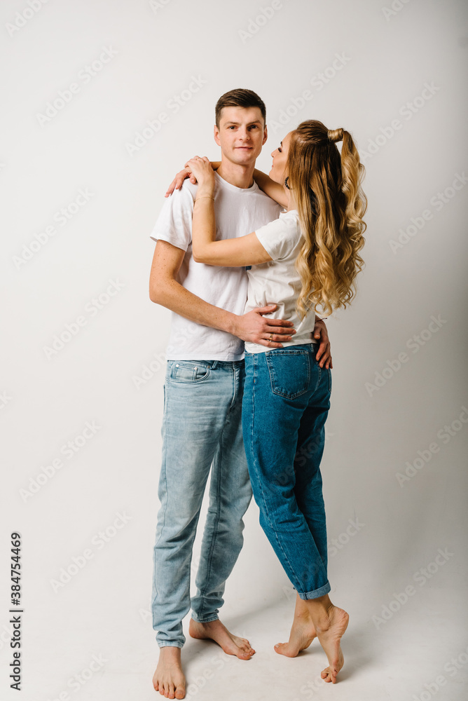 Couple in denim casual style clothes. Fashion models on white background. Smiling young man and woman posing together. Happy family couple. Couple in denim casual style clothes. Fashion models on white background. Smiling young man and woman posing together. Happy family couple.