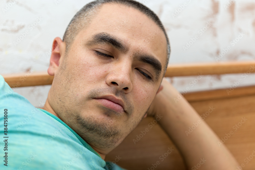 Obraz premium cute young man sleeping on the bed