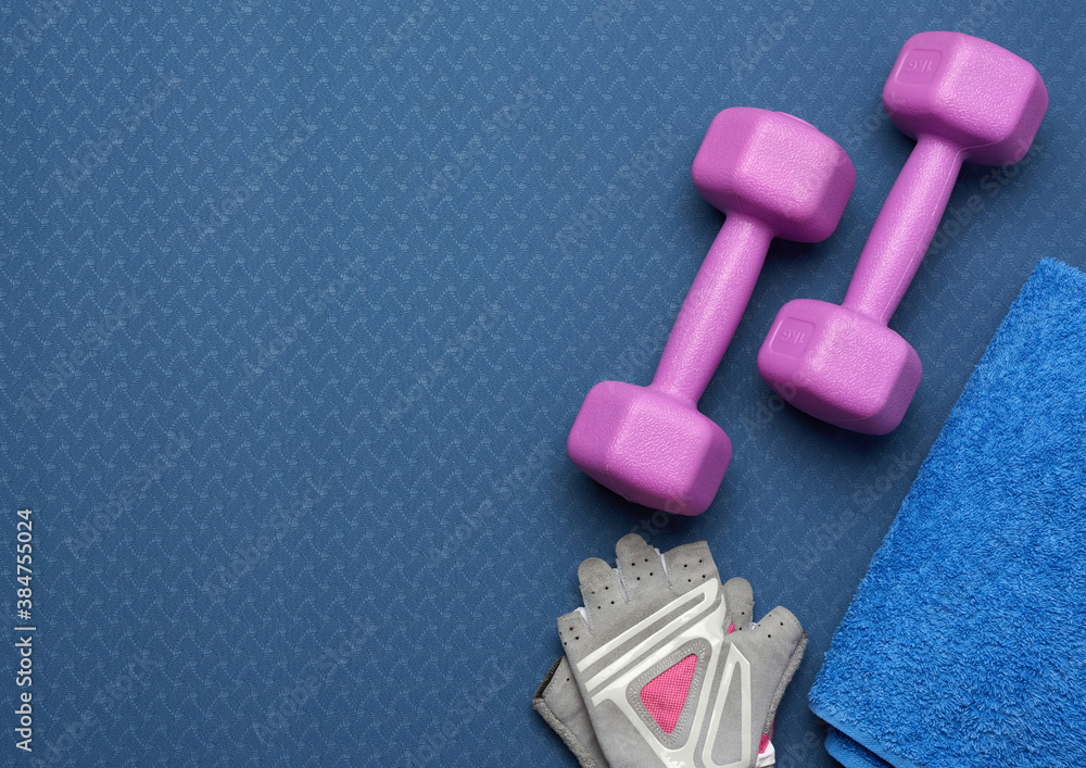 pair of dumbbells, sports gloves and blue towel pair of dumbbells, sports gloves and blue towel