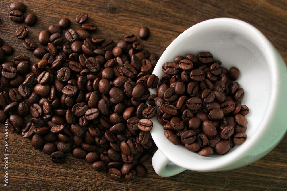 Coffee beans falling from a coffee mug