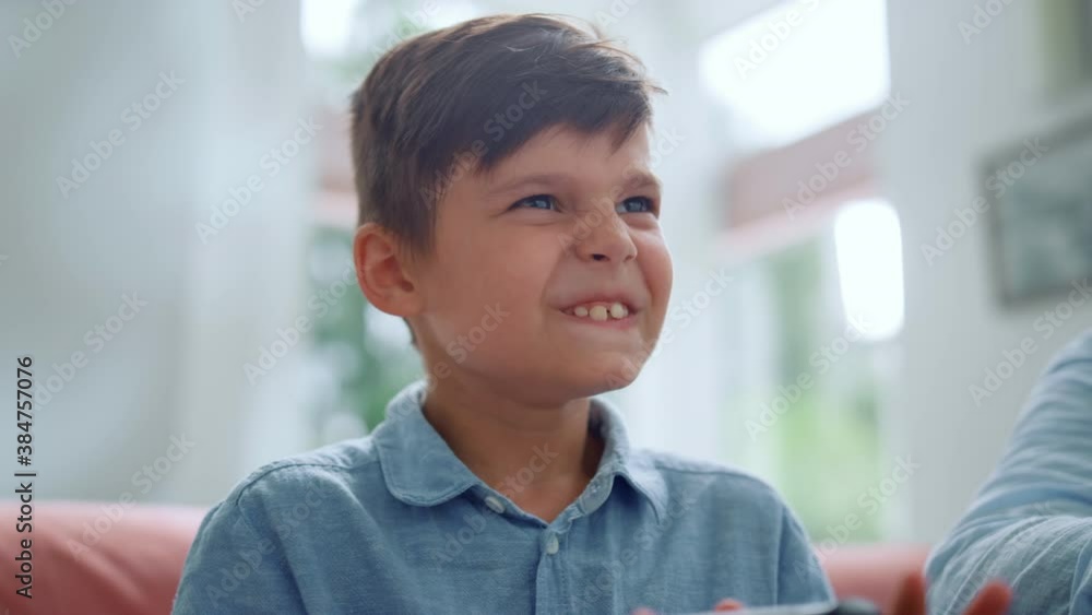 Focused boy playing video game. Emotional kid using joystick for computer game. Focused boy playing video game. Emotional kid using joystick for computer game.