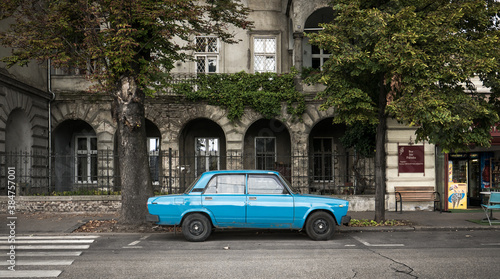 old car with old building in background in budapest