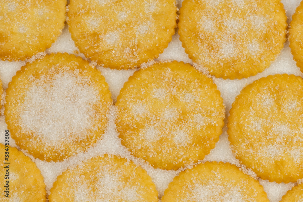 Spread of round cracker with sweet sugar isolated on white background Spread of round cracker with sweet sugar isolated on white background