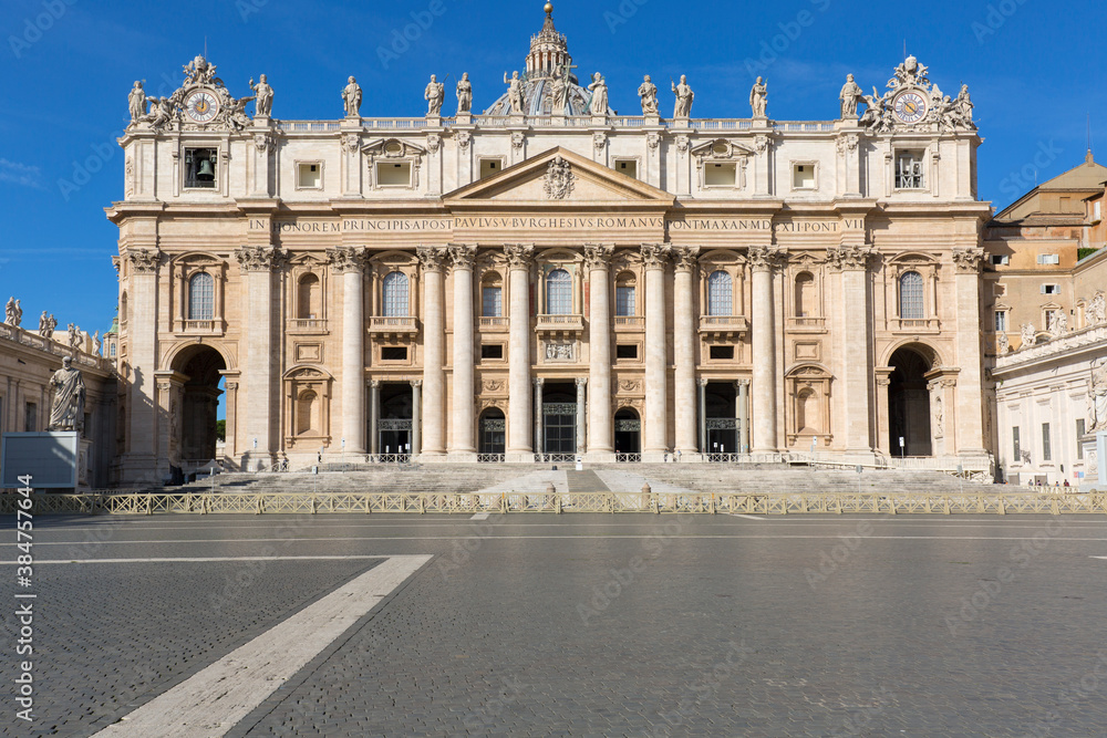 Facade of Saint Peter's Basilica at St.Peter's square. Few tourists wearing face masks due to the Covid-19 coronovirus pandemic, Vatican, Rome, Italy