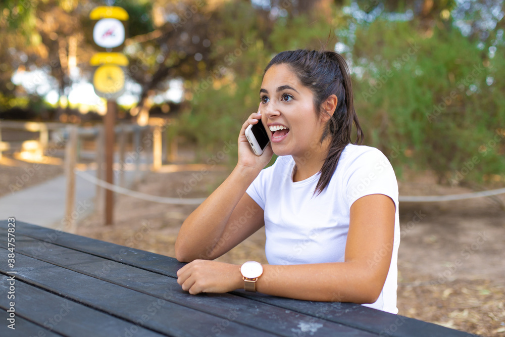 Young beautiful woman standing at the forest on a sunny day, smiling happy and cheerful talking on the phone Young beautiful woman standing at the forest on a sunny day, smiling happy and cheerful talking on the phone