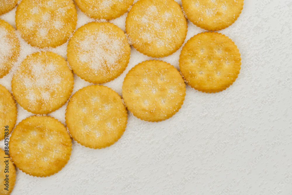 Spread of round cracker with sweet sugar isolated on white background Spread of round cracker with sweet sugar isolated on white background