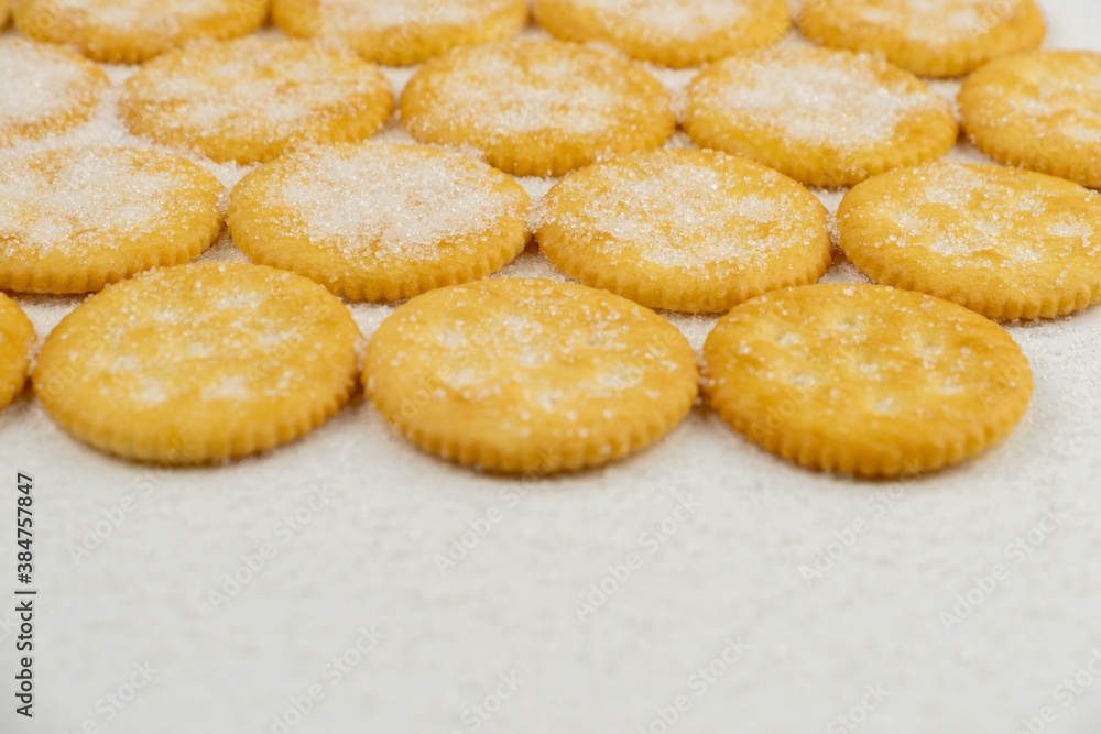 Spread of round cracker with sweet sugar isolated on white background Spread of round cracker with sweet sugar isolated on white background