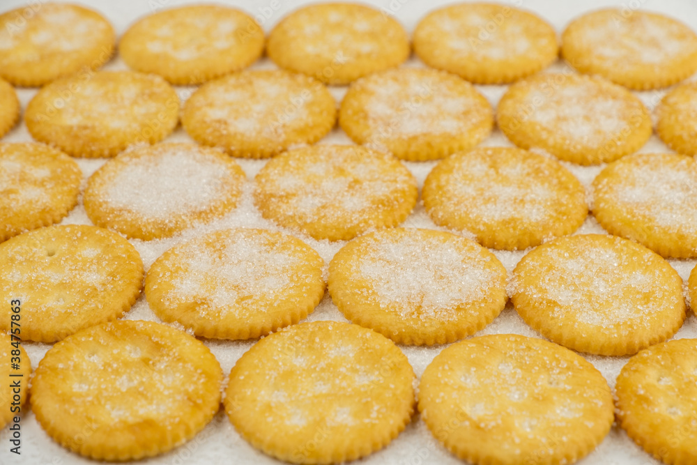 Spread of round cracker with sweet sugar isolated on white background Spread of round cracker with sweet sugar isolated on white background