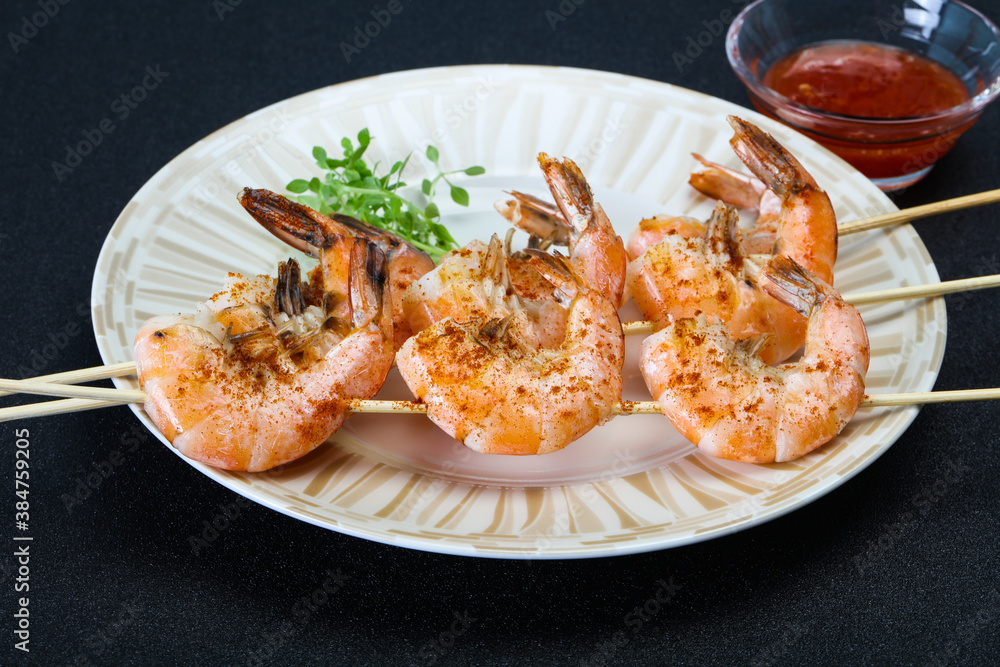 Grilled prawn skewer with sauce