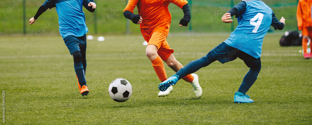 Boys Playing Soccer Game in Autumn Time. Footballers in Soccer Long Sleeve Jersey Clothing Boys Playing Soccer Game in Autumn Time. Footballers in Soccer Long Sleeve Jersey Clothing
