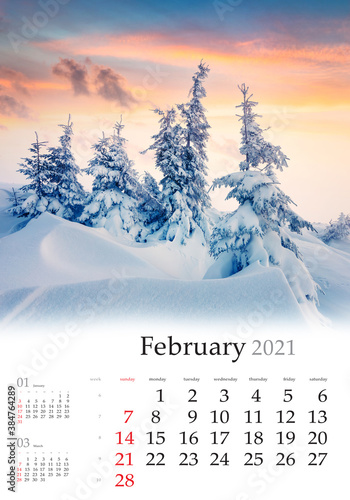 Calendar February 2021, vertical B3 size. Set of calendars with amazing landscapes. Attractive winter view of mountain forest. Spectacular sunrise in Carpathian mountains, Ukraine, Europe.. photo