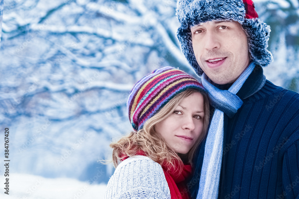 Stylish beautiful couple in winter park on a nature background Stylish beautiful couple in winter park on a nature background