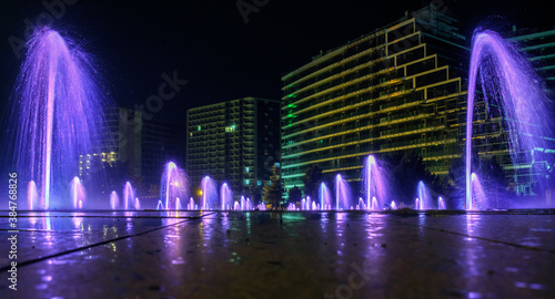 Night view of the dancing colored fountains with architectural background