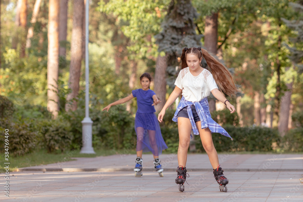 Girl rollerblading with her friend outdoors Girl rollerblading with her friend outdoors