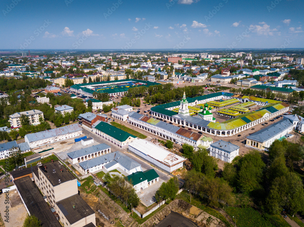 Fototapeta premium Scenic view from drone of Kostroma cityscape on bank of Volga River with complex of provincial trading arcades (Gostiny Dvor), Russia