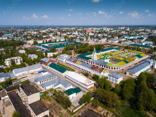 Scenic view from drone of Kostroma cityscape on bank of Volga River with complex of provincial trading arcades (Gostiny Dvor), Russia