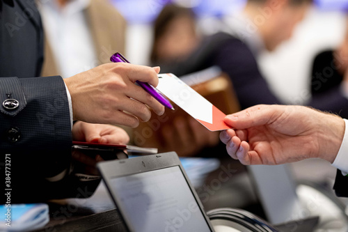 Handing Over a Ticket at an Event Registration 