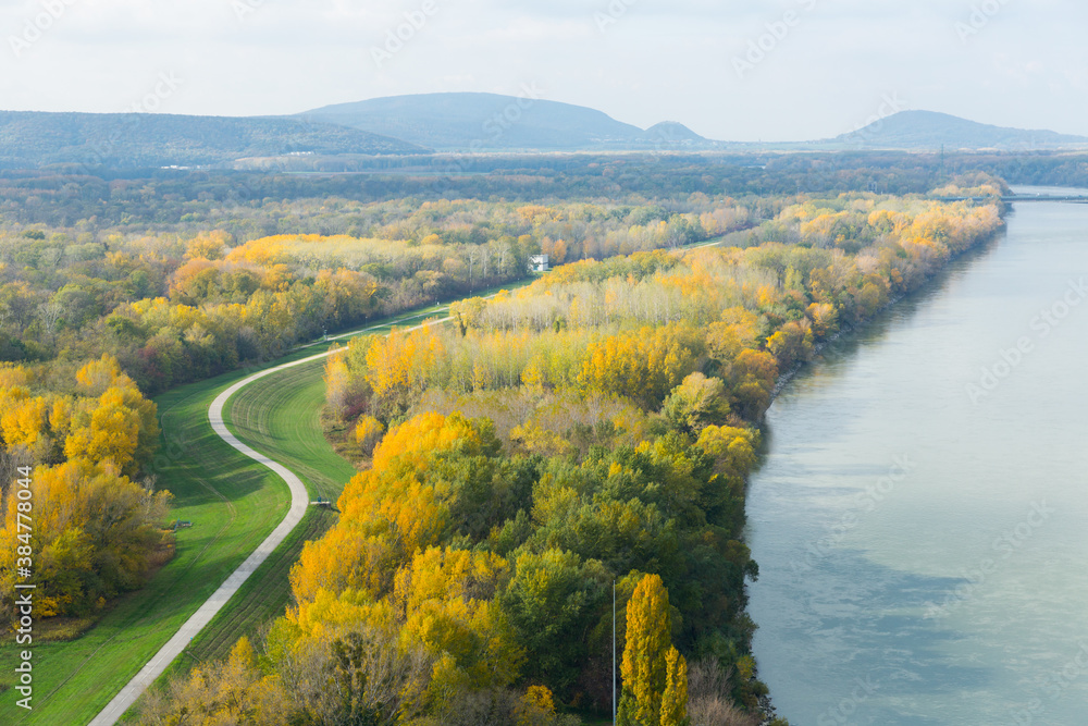 Aerial view of autumn landscape with river and curving road