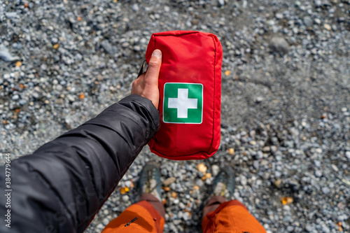 Guide is holding shiny first aid kit ready for action