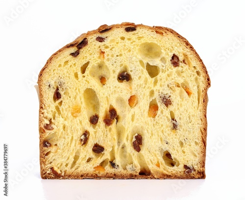 Panettone, traditional italian christmas dessert, cut in half with the texture of its classical recipe based by raisins, candied fruits and flour. White background