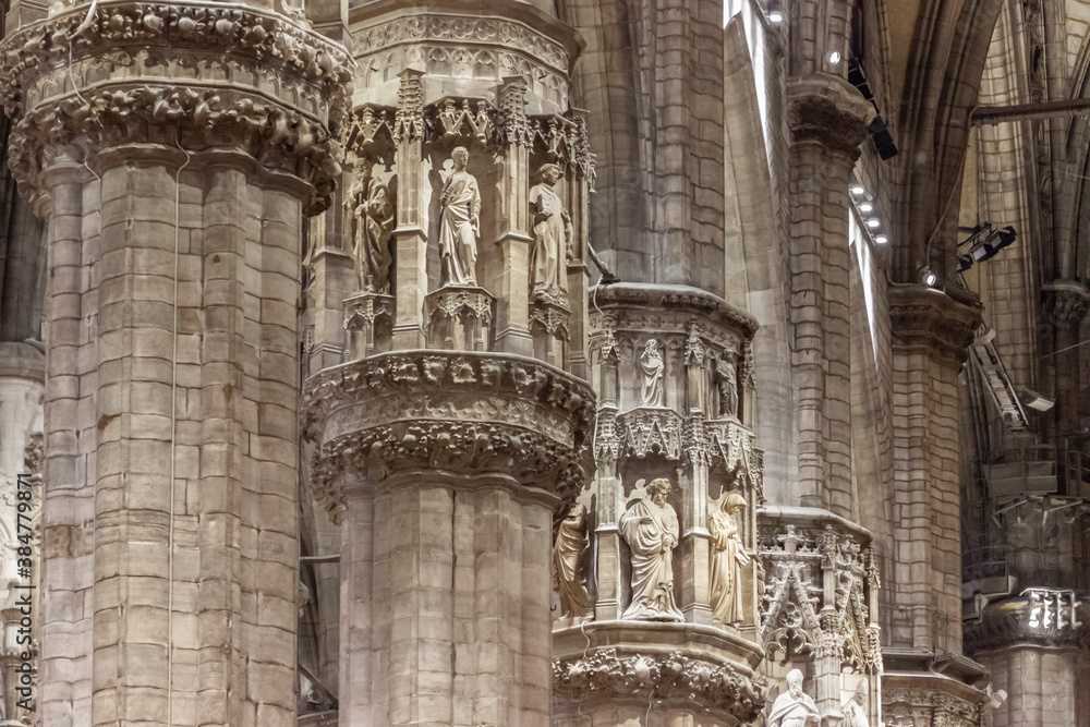 Decorative stone statues on the outer wall of the Cathedral of Milan - Duomo di Milano in Milan, Italy