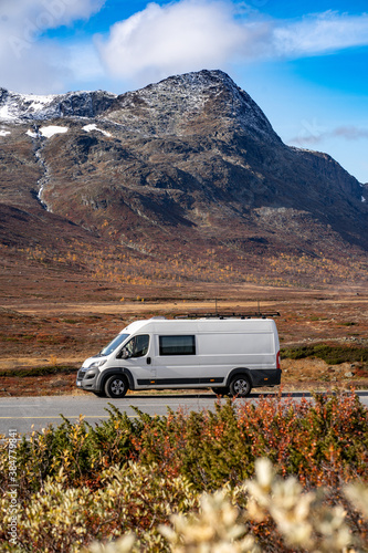 Campervan standing in the middle of Norwegian natural park 