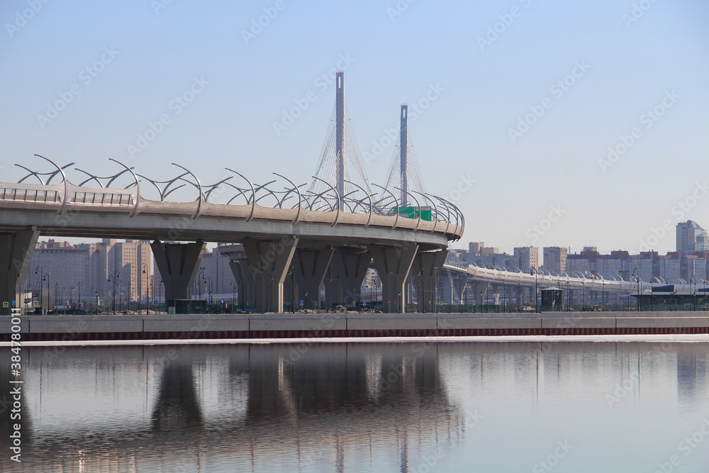 Fototapeta premium Construction of a large bridge across a wide river