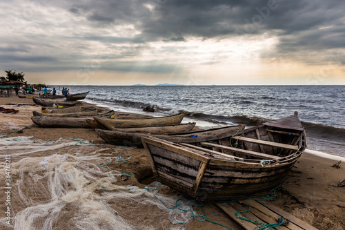 Boats on Lake Malawi beach with sun rays shining on water